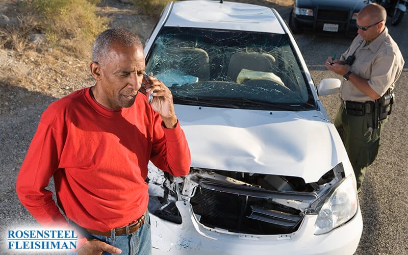 Man Using Phone to Call Police After a Car Accident