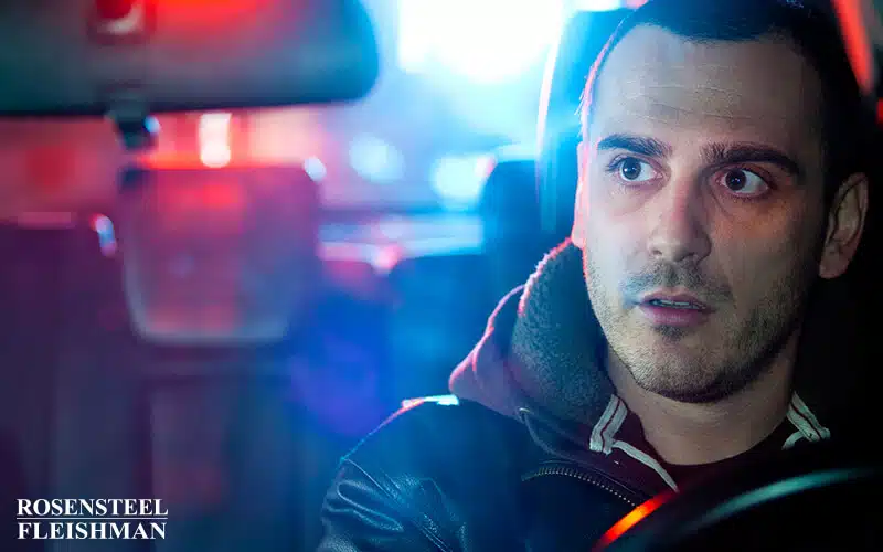 Police Pulling Over Man in Car